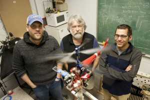 Anthony Westphal, left, a postdoctoral candidate studying marine and environmental sciences, Joseph Ayers, center, Professor of Neurophysiology and Behavior Biomimetics, and Dan Blustein, right, a doctoral student in biology, test autonomous flight components using a radio controlled helicopter as part of the RoboBees project, which aims to develop miniature, coordinated flying robots.