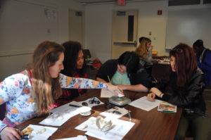 Students weigh shells for an experiment in an ocean acidification workshop presented by MIT SeaGrant.