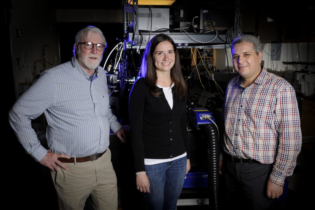 Paul Champion, professor and chair, Department of Physics, left, Bridget Salna, physics PhD candidate, and Research Associate Abdelkrim Benabbas, pose for a portrait in the Egan Research building at Northeastern University