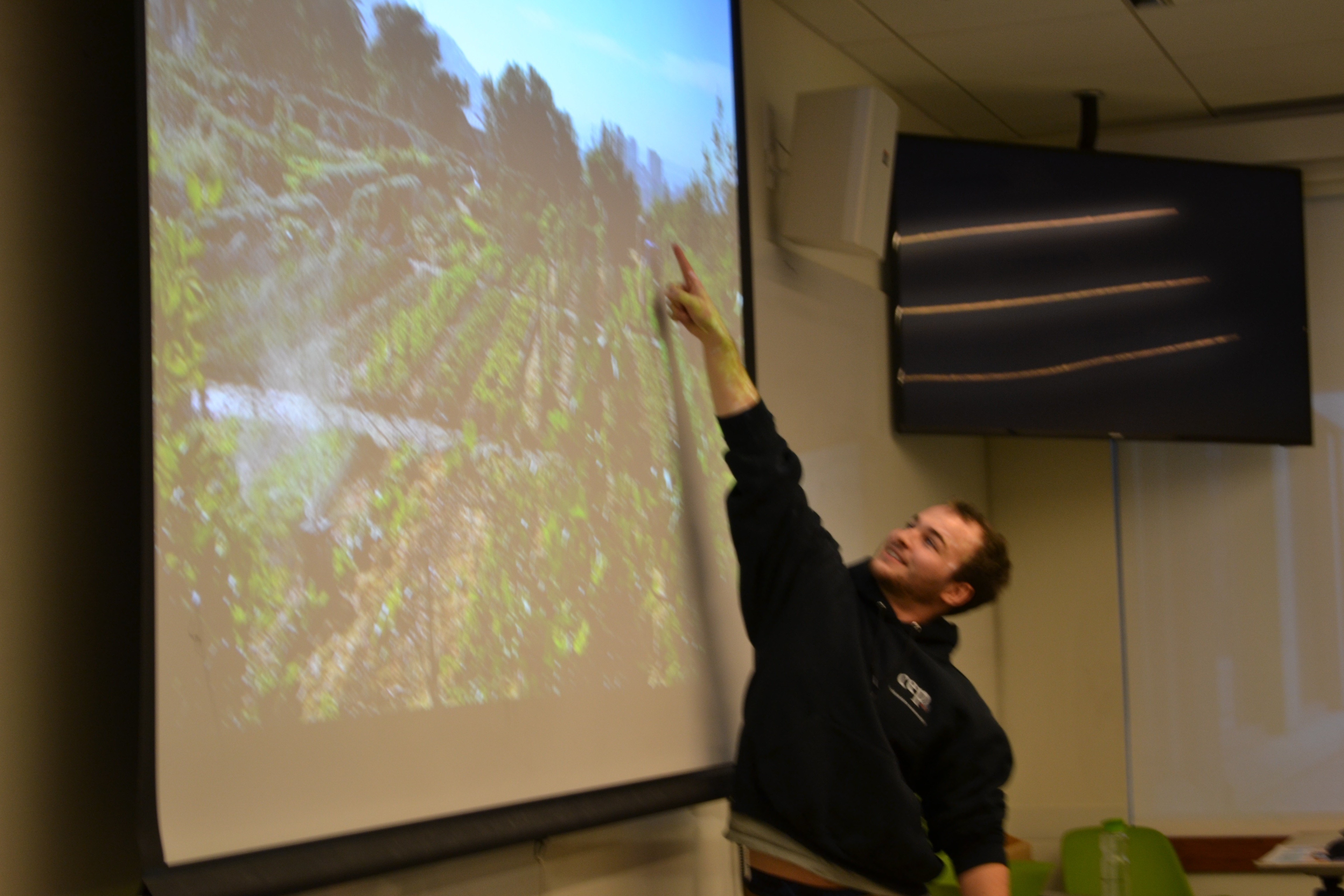 Kevin Freeman points out some of the crops on the farm where he worked for his co-op in Biology in South Africa.
