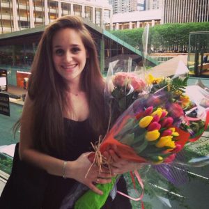 Gaby Aisenberg holds several bouquets of flowers