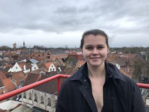 Ella Brunsting standing on a balcony looking over Bruges Belgium