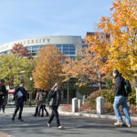 students walking through campus on a fall day