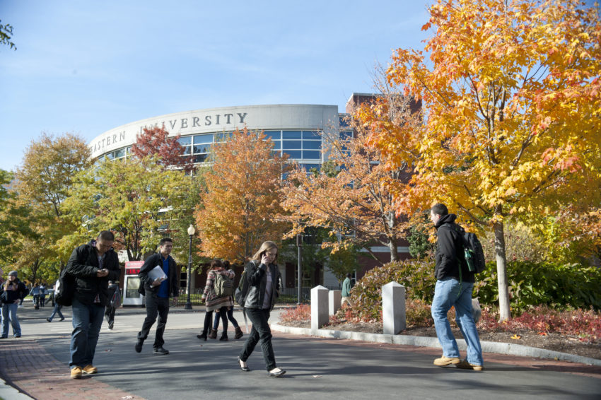 students walking through campus on a fall day