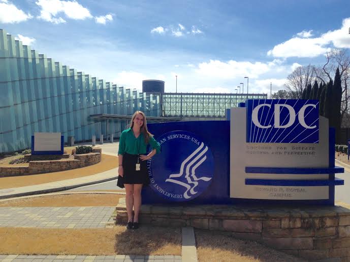 Nina Granow stands in front of the entrance sign at the Centers for Disease Control and Prevention.