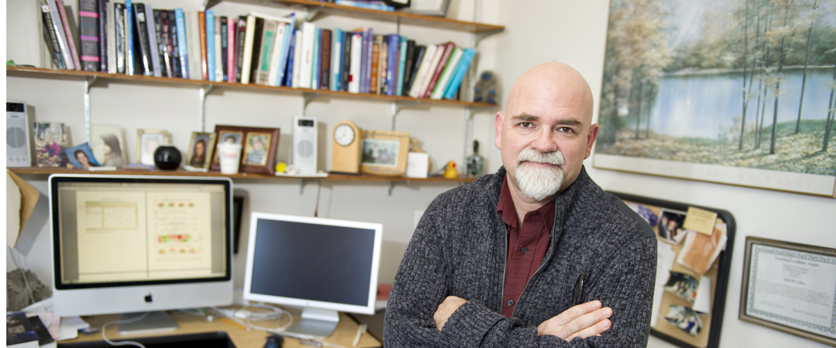 Psychology professor John Coley sits in his office