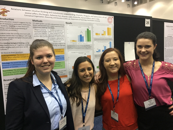 Four scientists stand in front of their research poster at the conference