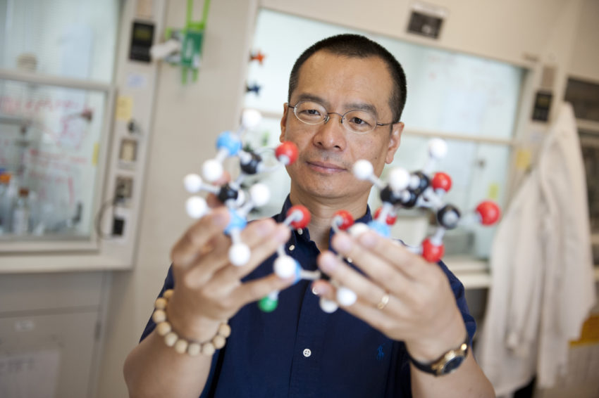 Sunny Zhou in his lab with molecular models.