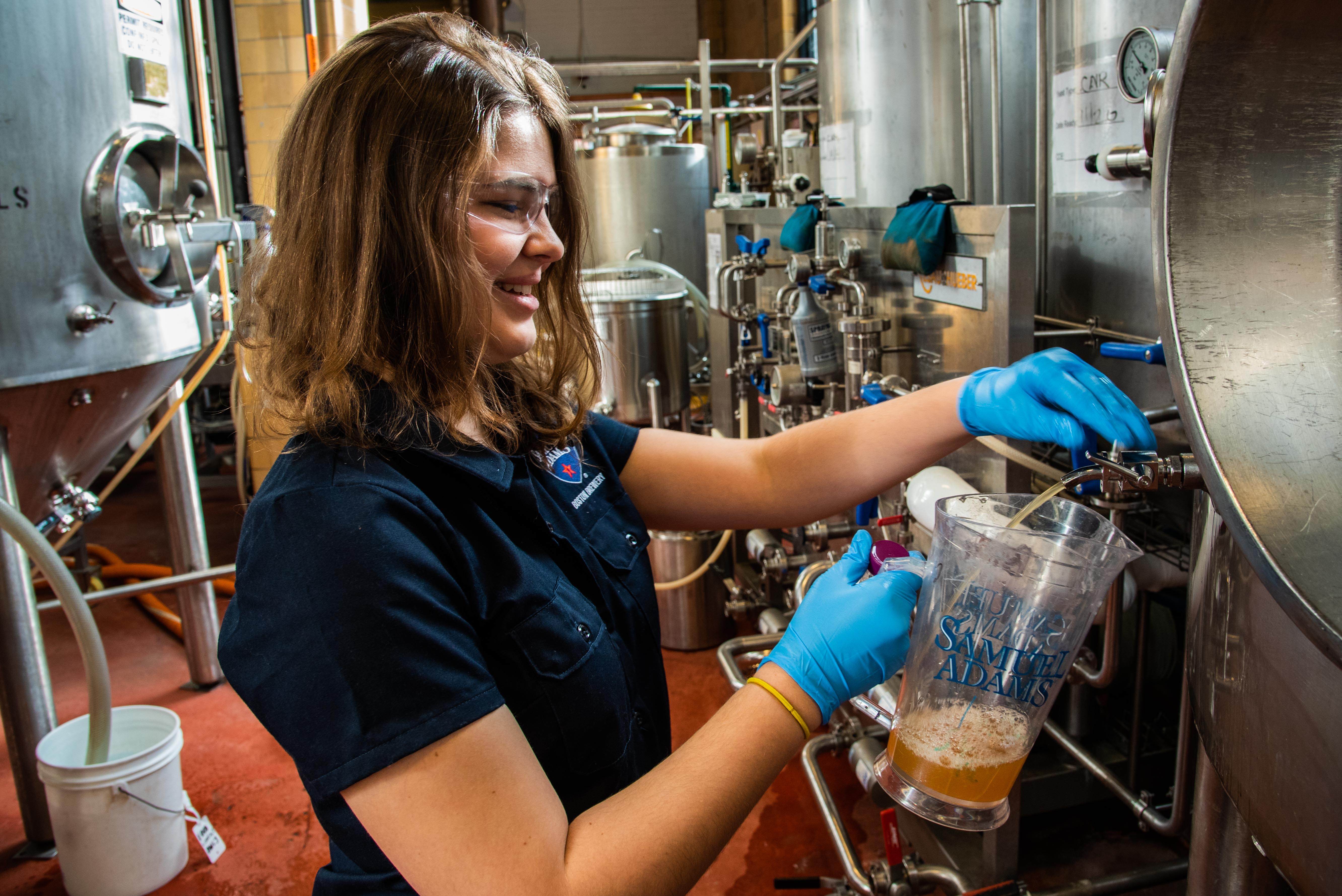 Elizabeth Curtis, Biology '19, pours a pint of lager at the Boston Beer Company in Jamaica Plain. Photo by Tim Briggs