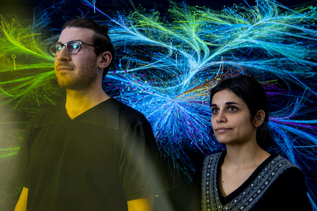 11/12/19 - BOSTON, MA. - Doctoral students Alex Gates and Alice Grishchenko pose for a portrait at the The Network Science Institute on on Nov. 12, 2019. Both were the leaders on a project which analyzed, organized and visualized 150 years of scientific articles by the British journal Nature. Photo by Matthew Modoono/Northeastern University
