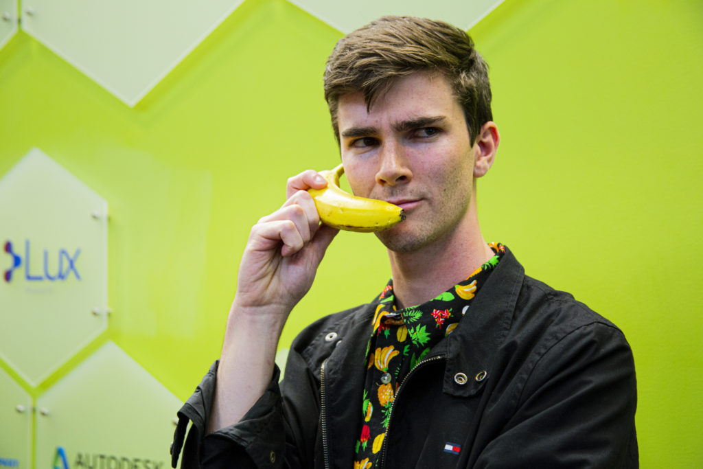 Coghlan holds a banana coated in Cambridge Crops' food preservation solution. Photo by John McCarthy/College of Science