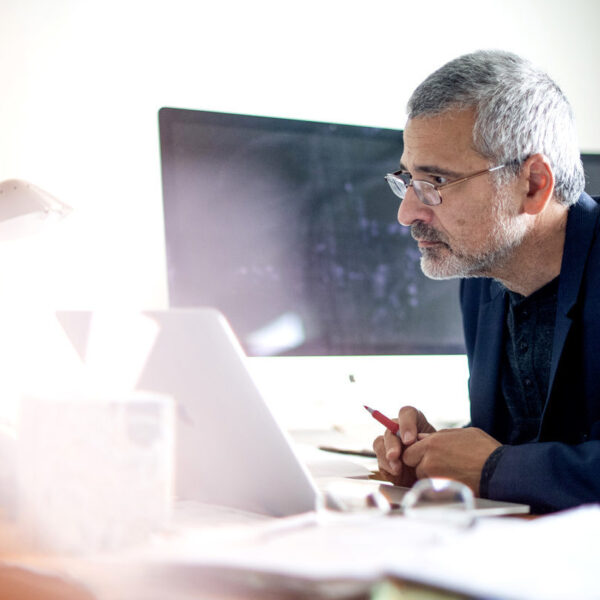 Photo of Alessandro Vespignani at his desk.