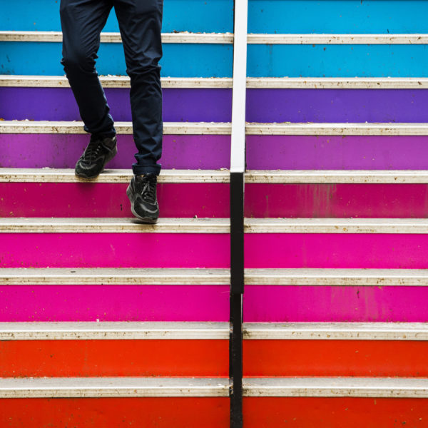 student walking down multi-colored steps