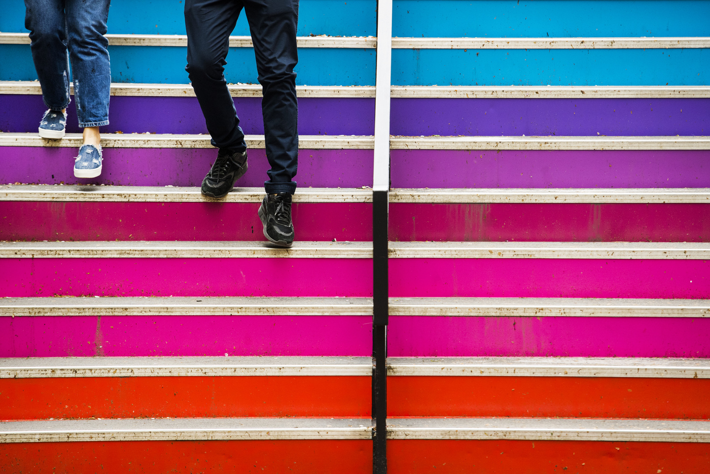 student walking down multi-colored steps