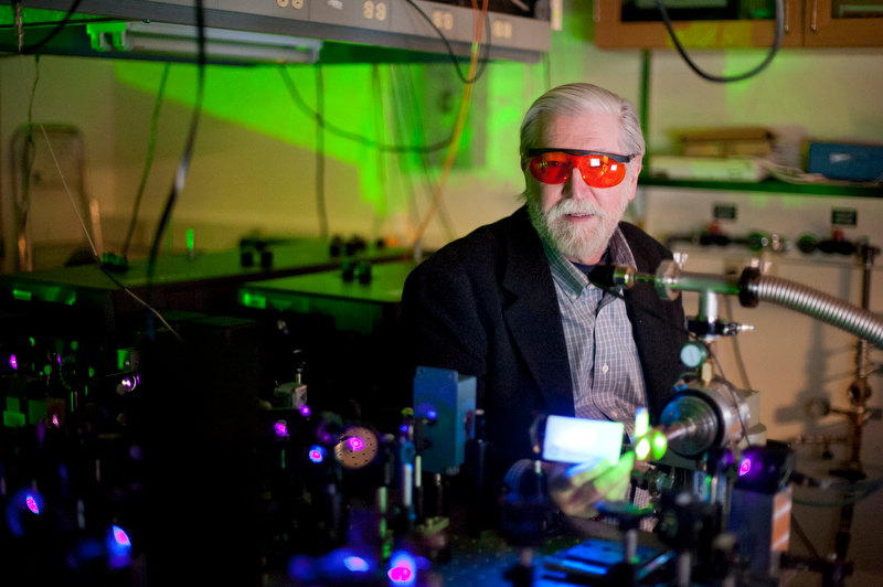 photo of professor Paul Champion with red goggles in the lab