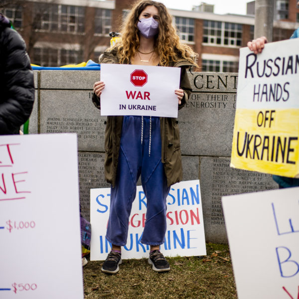 students protest the russian invasion of ukraine on centennial, holding up various signs