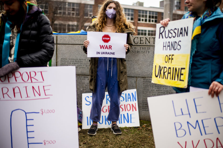 students protest the russian invasion of ukraine on centennial, holding up various signs