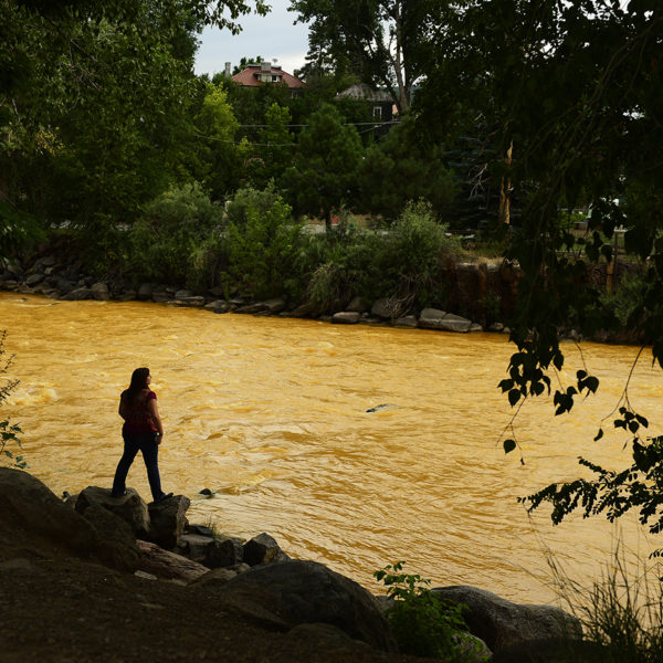 Kalyn Green, resident of Durango, stands on the edge of the river August 6, 2015 along Animas River.