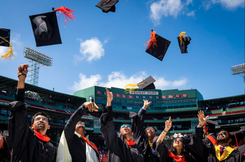 Caps were flying Friday morning at the Commencement ceremony for graduate students at Fenway Park