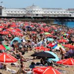 Umbrellas cover a crowded beach