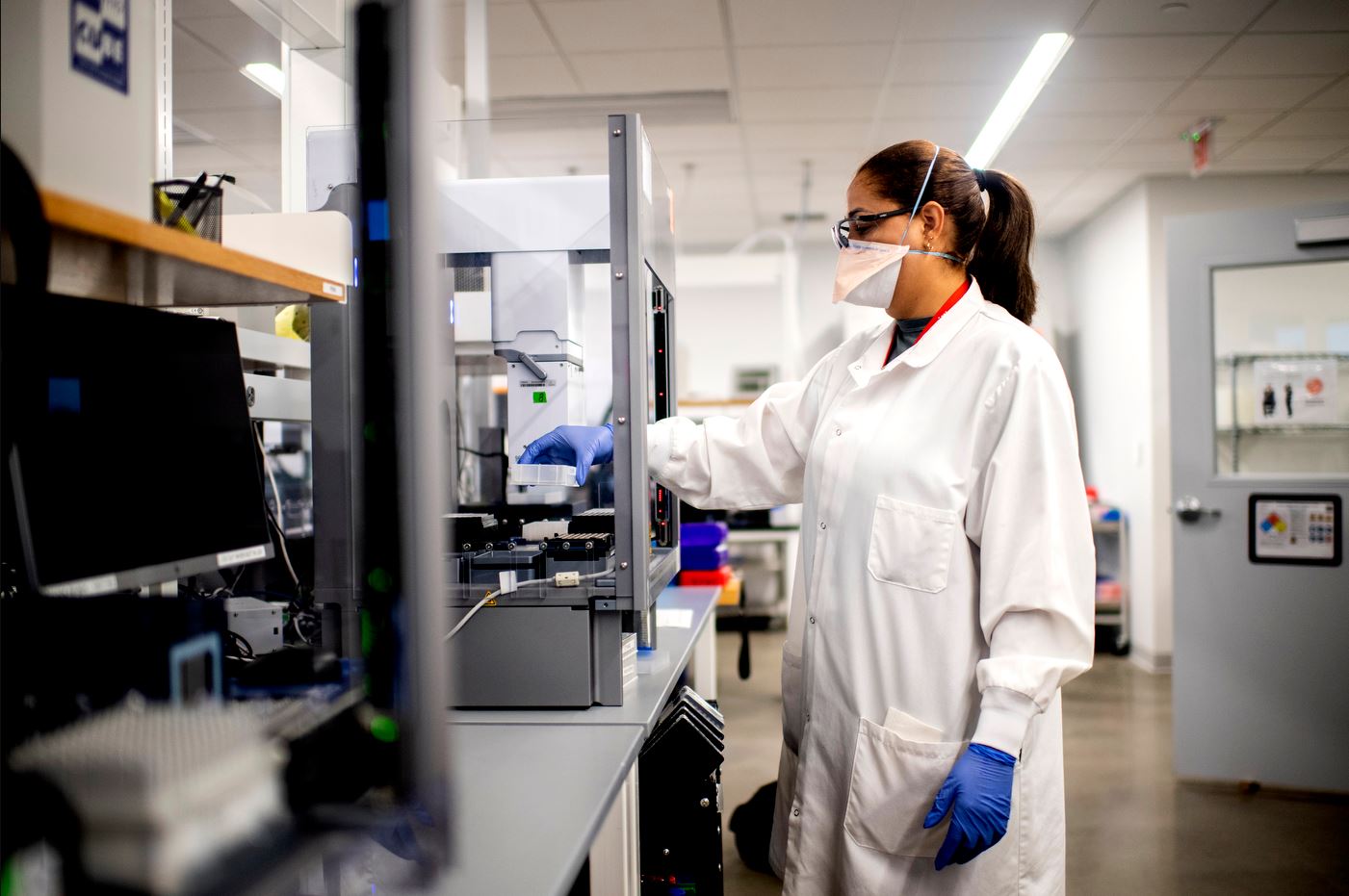 Lab technician in white lab coat is conducting testing