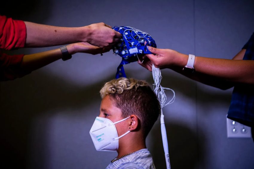 Pryce, 9, is fitted with a sensory cap before undergoing tests at the Center for Cognitive and Brain Health