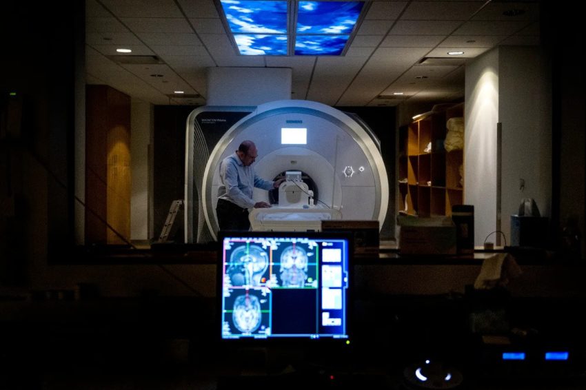 Jonathan Peelle works next to an MRI machine