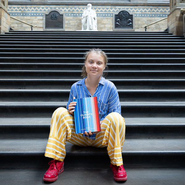 Climate activist Greta Thunberg sits for a photo on steps
