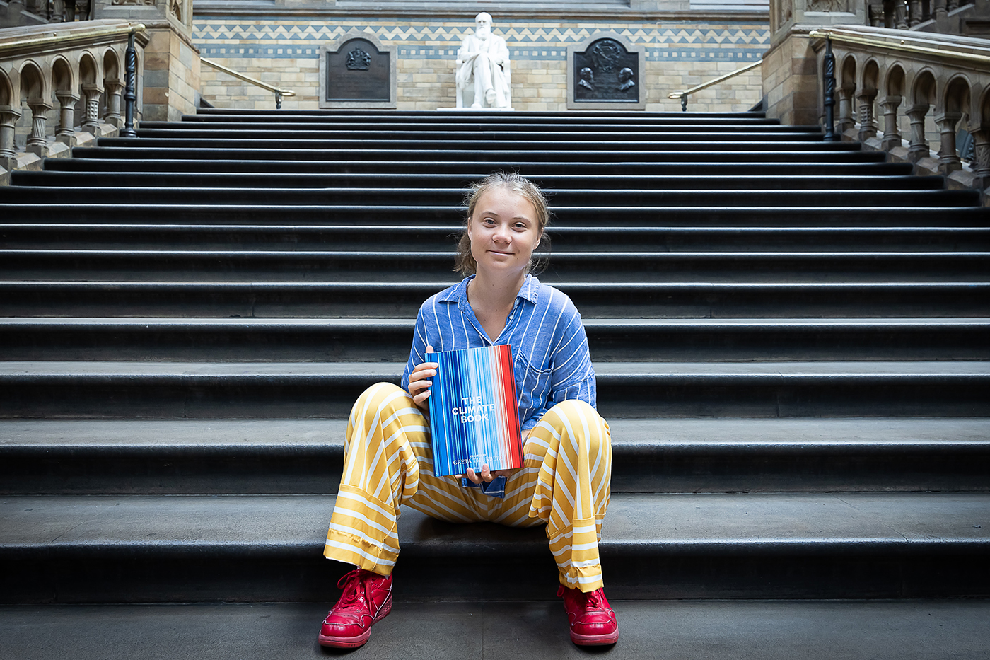 Climate activist Greta Thunberg sits for a photo on steps