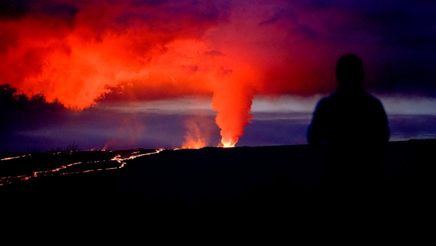 Person watches volcano eruption