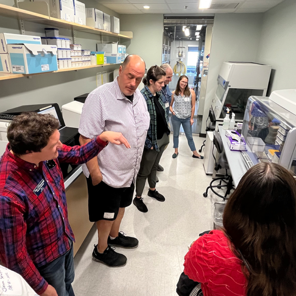 Members of the Grabowski, Vollmer, and OGL lab teams from CSI receive a tour of the laboratory space from GMGI Research Scientist Tim O’Donnell.