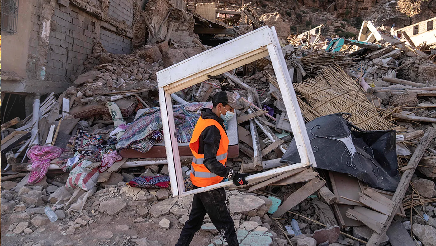 A volunteer helps salvage furniture from homes which were damaged by the earthquake, in the town of Imi N’tala, outside Marrakech, Morocco, Wednesday, Sept. 13, 2023.