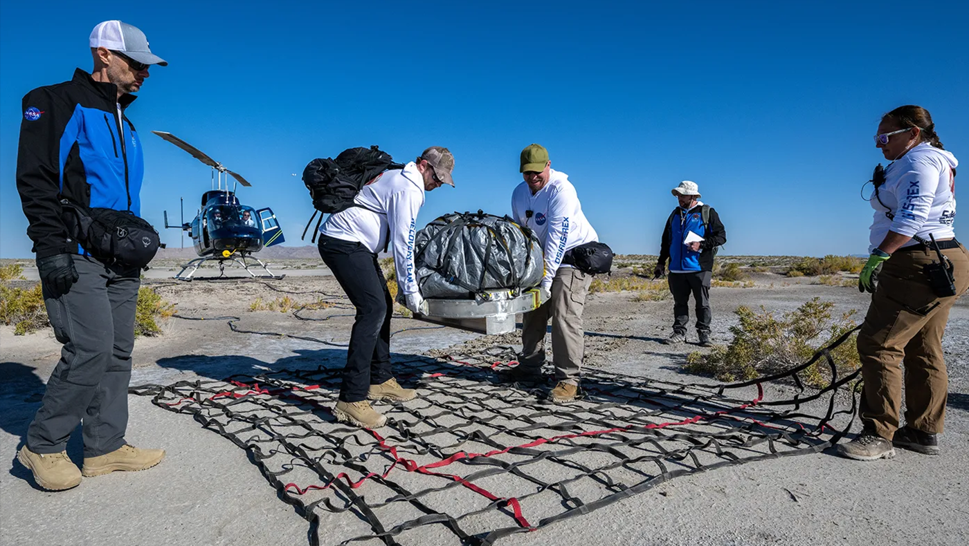 Recovery team members prepare the sample return capsule from NASA’s OSIRIS-REx mission for transport to the cleanroom, Sunday, Sept. 24, 2023, shortly after the capsule landed at the Department of Defense’s Utah Test and Training Range. The sample was collected from the asteroid Bennu in October 2020 by NASA’s OSIRIS-REx spacecraft