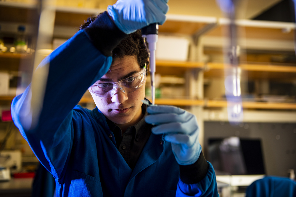 Dillon Nishigaya conducts research in a lab.