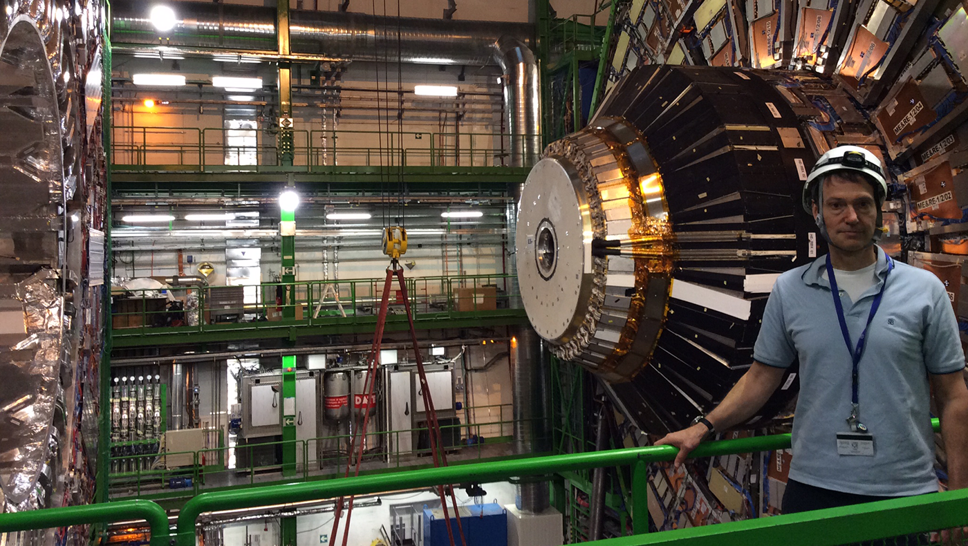 Darien Wood poses with a particle accelerator.