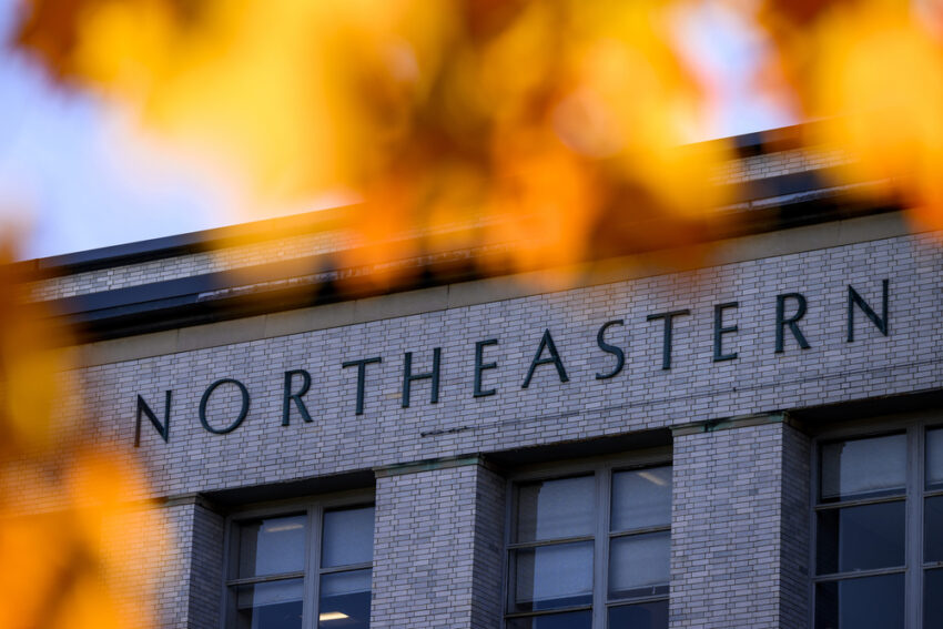A picture of a building on Northeastern's Boston campus surrounded by fall leaves.