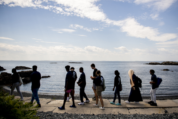 Students walking along path overlooking the ocean at the Nahant campus.