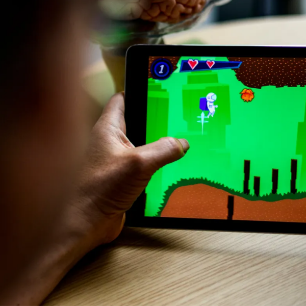 Up close shot of someone's hands on a tablet. The person seems to be playing a game on the tablet.