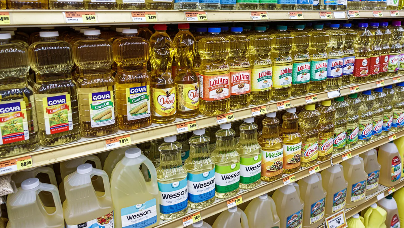 Pictures of oils on a grocery store shelf.