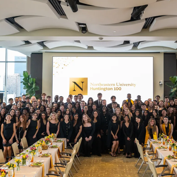Photo of a group of people behind a set of banquet tables.