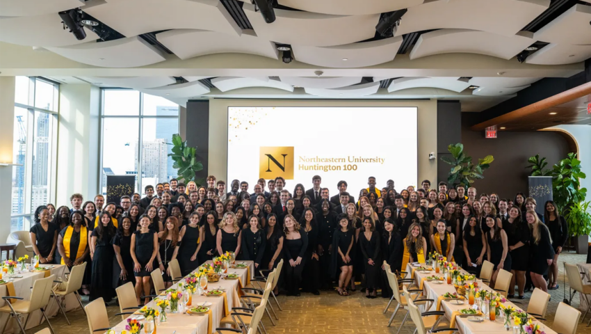 Photo of a group of people behind a set of banquet tables.