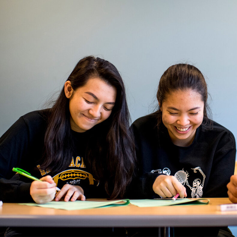 three students work on calculus problem together